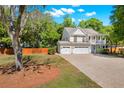 Traditional style home with white siding, a double garage, and a spacious front yard, perfect for outdoor activities at 2828 Olivia Marie Ln, Johns Island, SC 29455