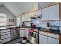 Modern kitchen with stainless steel appliances, granite countertops, and white cabinetry at 301 Factors Walk, Summerville, SC 29485