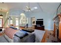 Bright living room with vaulted ceiling, skylight, hardwood floors, and a cozy fireplace at 301 Factors Walk, Summerville, SC 29485