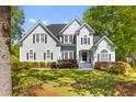 Two-story home with blue siding and black shutters, complemented by a well-manicured lawn and established landscaping at 3500 Maplewood Ln, Mount Pleasant, SC 29466