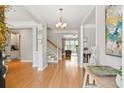 Spacious foyer boasts hardwood floors, a chandelier, and beautiful staircase at 3526 Stockton Dr, Mount Pleasant, SC 29466