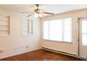 Bright living room featuring hardwood floors, built-in shelving, and plenty of natural light from a large window at 356 Price St, Goose Creek, SC 29445