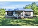 Well-maintained house with a metal roof, shutters, and a welcoming front porch at 416 Jelly Rolls Rd, Moncks Corner, SC 29461