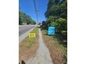 Real estate signs display 'For Sale' and 'Open House Everyday' along a sidewalk and street at 4165 Dorchester Rd, North Charleston, SC 29405
