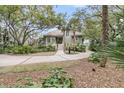 Inviting home exterior with lush landscaping and winding driveway at 418 Snowy Egret Ln, Kiawah Island, SC 29455