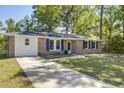 Single story brick home with lush front lawn and a paved driveway leading to the entrance at 4412 Garwood Dr, Ladson, SC 29456