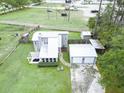 Aerial view of the home with a large lot, detached garage, back patio, and privacy fence at 49 Auld Brass Rd, Walterboro, SC 29488