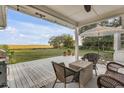 Relax on the inviting back porch with marsh views and stylish outdoor furniture at 561 Seaward Dr, Charleston, SC 29412