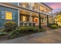 Charming two-story home with a covered porch, mature trees, and a well-manicured lawn at 66 Warren St # Main House Only, Charleston, SC 29403