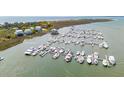 Aerial view of a coastal community marina showcasing boat docks, waterways, and nearby beachfront properties at 68 W 9Th St # B, Folly Beach, SC 29439