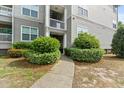 Apartment entrance with well-manicured bushes alongside the concrete walkway to the front door at 700 Daniel Ellis Dr # 3208, Charleston, SC 29412