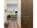 Inviting foyer showcasing a hardwood floor, modern bench, and a view into the living room at 700 Daniel Ellis Dr # 3208, Charleston, SC 29412