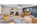 Comfortable living room featuring a cozy fireplace, hardwood floors, and ample seating at 8363 Water Ash Way, North Charleston, SC 29420