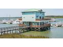 Exterior of the unique waterfront property featuring balconies and access to boat slips at 0 We 10Th St, Folly Beach, SC 29439