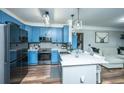Open kitchen featuring blue cabinets, stainless appliances, and a view to the living area at 1025 Riverland Woods Pl # 1108, Charleston, SC 29412