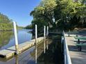 A community dock with picnic tables, a walkway, and beautiful waterfront views on a sunny day at 104 Huntington Cir, Summerville, SC 29485
