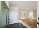 Bright foyer featuring black slate flooring and a view of the open concept living space and hardwood floors at 104 Huntington Cir, Summerville, SC 29485