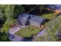 Aerial view of a well-maintained property with lush greenery, a fenced-in backyard, and a long driveway at 1049 Bradford Ave, Charleston, SC 29412