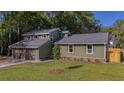 Beautiful two-story house featuring an attached garage, well-kept lawn, and charming exterior details at 1049 Bradford Ave, Charleston, SC 29412