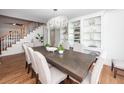 Bright dining room with hardwood floors, a chandelier, and white shelving at 105 Kirkhaven Ct, Goose Creek, SC 29445