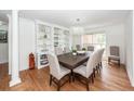 Elegant dining room features hardwood floors, built-in shelving, and a modern chandelier at 105 Kirkhaven Ct, Goose Creek, SC 29445