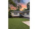 Charming home featuring a well-manicured lawn and inviting curb appeal at sunset at 1120 Seaside Ln, Charleston, SC 29412