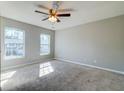 Spacious bedroom with neutral carpet, ceiling fan and two windows providing natural light at 118 Willowbend Ln, Summerville, SC 29485