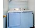 Modern laundry room with white, front-loading washer and dryer at 118 Willowbend Ln, Summerville, SC 29485