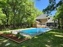 Inviting backyard pool area with well-maintained pool and lush landscaping; perfect for relaxation at 130 Delaney Cir, Summerville, SC 29485