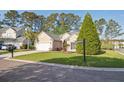 Well-maintained single-story house boasts a pristine lawn, two-car garage, and neatly trimmed shrubs at 1409 Endicot Way, Mount Pleasant, SC 29466