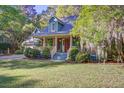 Lovely two-story home with a covered porch and mature trees in the front yard at 1417 Pine Island View, Mount Pleasant, SC 29464