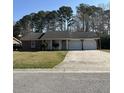 Charming single-story home with a well-manicured lawn and a two-car garage at 142 Aylesbury Rd, Goose Creek, SC 29445