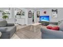 Cozy living room with plush seating, neutral decor, and a view into a modern kitchen with open shelving at 1450 E Montague Ave, North Charleston, SC 29405