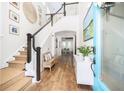Bright foyer featuring hardwood floors, staircase, and decor, offering a welcoming first impression at 1526 Old Rivers Gate Rd, Mount Pleasant, SC 29466