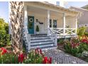Inviting front porch with brick stairs, beautiful flowerbeds, and a turquoise door, enhancing curb appeal at 1526 Old Rivers Gate Rd, Mount Pleasant, SC 29466