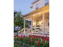 Charming front porch of a white home with a welcoming entrance, complete with lovely landscaping and stylish lighting at 1526 Old Rivers Gate Rd, Mount Pleasant, SC 29466