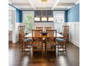 Elegant dining room with wainscoting, blue textured wallpaper, coffered ceiling, and seating for eight at 1562 Charming Nancy Rd, Charleston, SC 29412