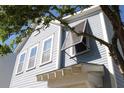 Light blue home featuring white trim, awning and many windows at 1651 Indy Dr, North Charleston, SC 29405
