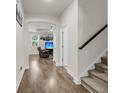 Bright hallway with wood-look flooring, leading to the staircase and living room at 171 Sara St, Saint George, SC 29477