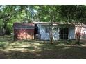 View of the backyard with a structure that has white siding and a brick rear wall at 202 Easy, Goose Creek, SC 29445