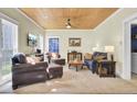 Cozy living room with wood ceiling, comfortable seating, and natural light at 2021 Beckton St, North Charleston, SC 29420