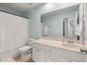 Bright bathroom featuring a white vanity, large mirror, and tub with a shower and white shower curtain at 210 Witch Hazel St, Summerville, SC 29486