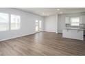 Open-concept living and kitchen area with lots of natural light and wood-look flooring at 211 W Bradford Pointe Dr Dr, Summerville, SC 29483