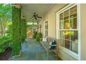 Covered front porch with bluestone floor and bench seating at 22 Fairhope Rd, Mount Pleasant, SC 29464