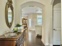 Elegant entryway featuring hardwood floors, an ornate mirror, and an arched doorway leading to the living areas at 222 Stone Village Cir, Summerville, SC 29486