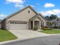 Inviting single-Gathering home boasting stone detailing, attached garage, and a neat front yard with healthy shrubs at 222 Stone Village Cir, Summerville, SC 29486