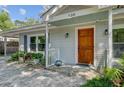 Inviting front entrance features a wood door, manicured landscaping, and charming details at 238 Howle Ave, Charleston, SC 29412