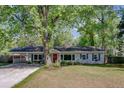 Charming single-story home with light gray siding, inviting front yard and mature trees at 238 Howle Ave, Charleston, SC 29412