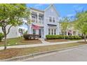Charming two-story home featuring a balcony, light blue siding, manicured landscaping, and inviting curb appeal at 245 Ribbon Rd, Summerville, SC 29483