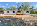 Charming single-story home with traditional style siding and a wood porch and stairs at 254 Nelson Farm Ln, Cross, SC 29436